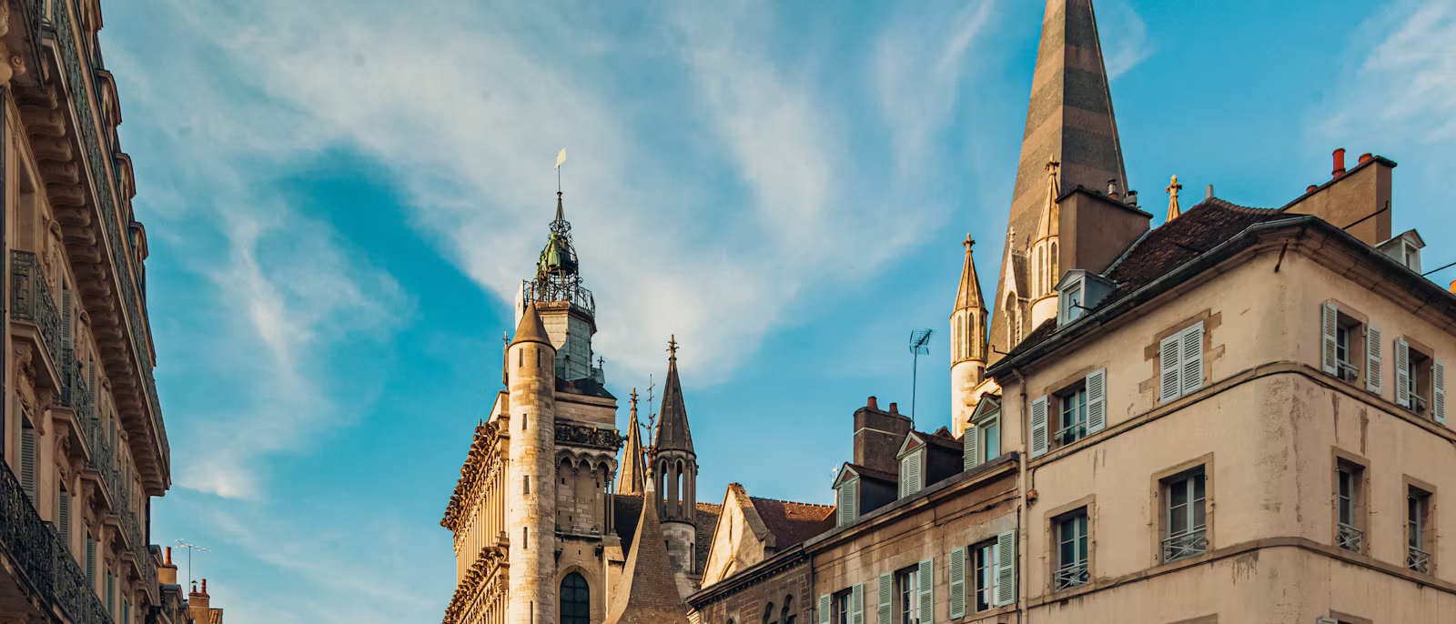 Notre-Dame de Dijon's towers and spire above old town facades