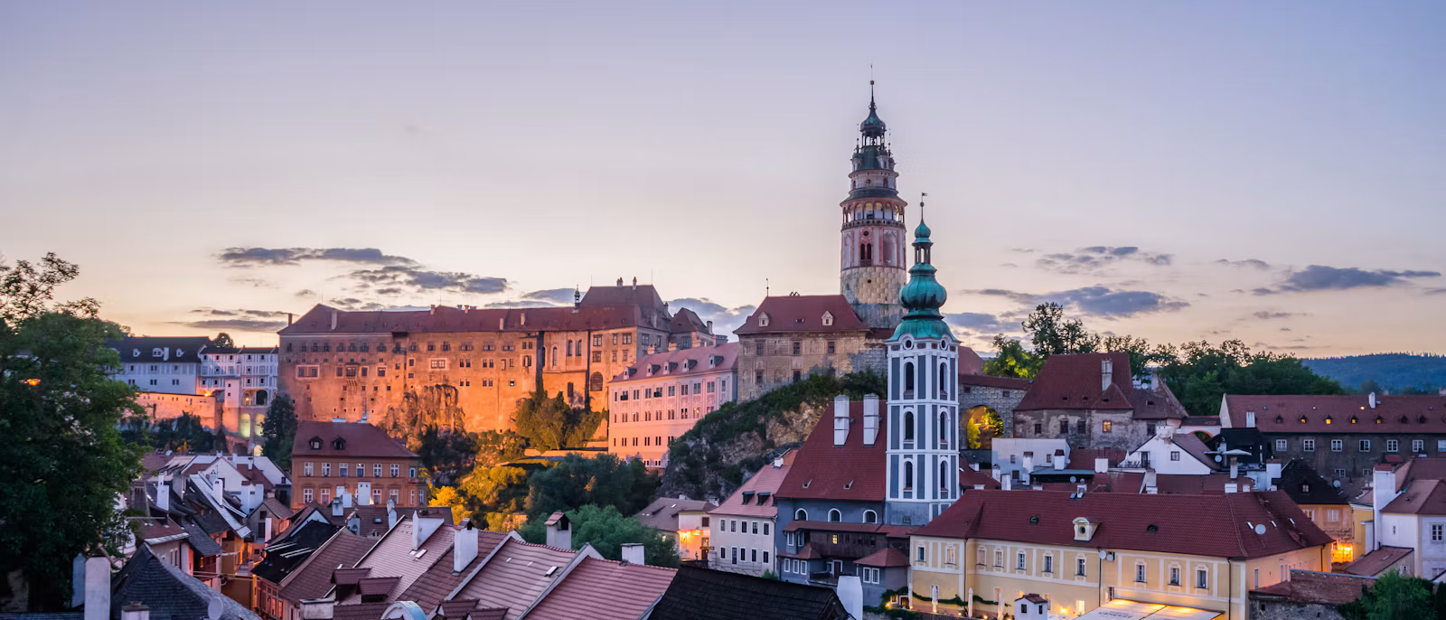 Český Krumlov's old town of red roofs inside the bend of the Vltava, below the castle tower